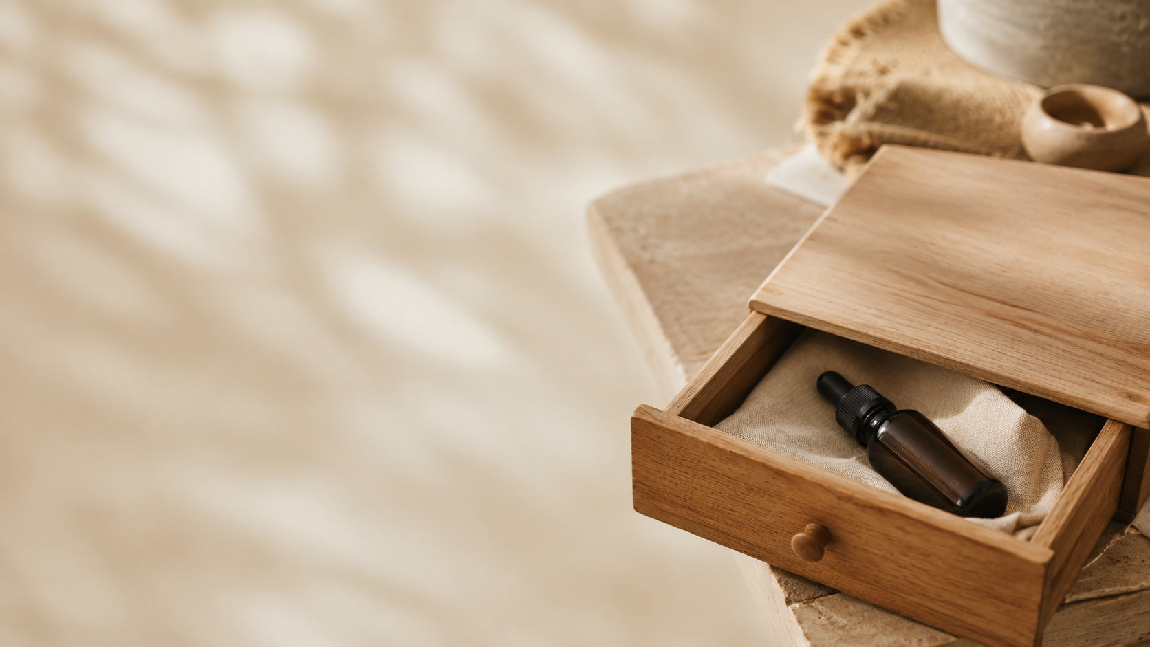 Amber CBD oil bottle stored inside a partially closed wooden drawer, symbolizing taking a break from CBD oil in a calm wellness setting.