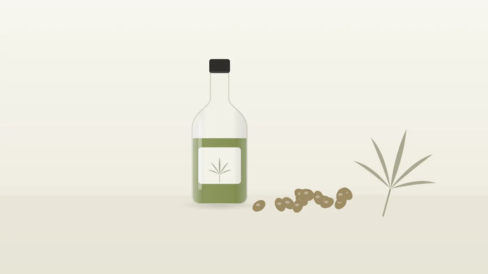 Flasche mit grünem Hanföl und Hanfsamen neben einem Hanfblatt